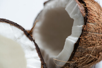 close up view of tasty coconut halves on white background