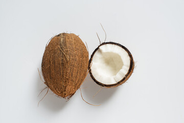 top view of fresh tasty whole coconut and half on white background