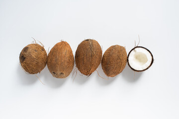 top view of fresh tasty whole coconuts and half on white background