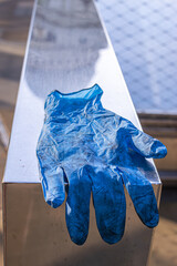 Photo of a blue plastic glove on the streets of London during pandemic times