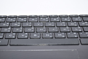 Laptop keyboard thai language on white background.