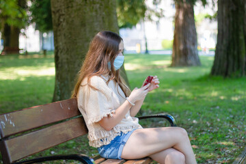 girl sitting on the street with face mask