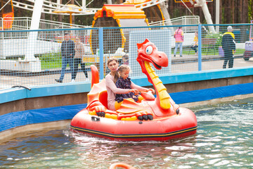Mom and daughter ride on the water attraction