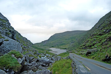 Fototapeta na wymiar Road through the landscape with a lake in the background, Ireland
