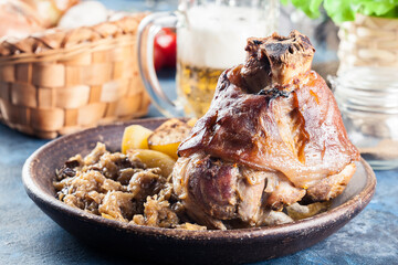 Pork knuckle with fried sauerkraut and baked potatoes