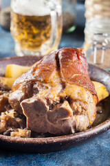 Pork knuckle with fried sauerkraut and baked potatoes