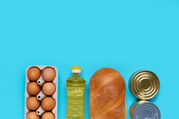 Top view, flatlay. Set of products on the blue background. Food from the store. Sunflower oil,...