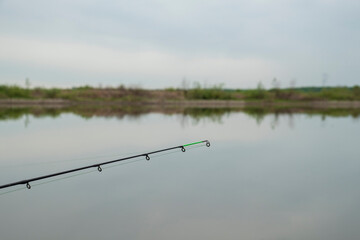 Feeder fishing on the lake. Focus on fishing rod.