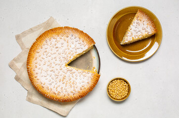 Italian Grandma's cake - Torta della nonna.  Pine nut custard tart from Tuscany, Italy. Flat lay.