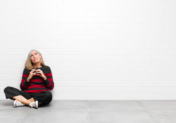 senior or middle age pretty woman scheming and conspiring, thinking devious tricks and cheats,...