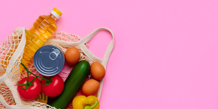 Fresh vegetables and foods in the string bag. Chicken eggs, zucchini, tomatoes, sunflower oil, yellow fresh pepper