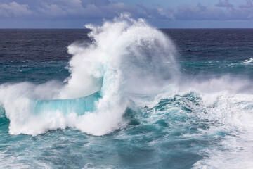 Fototapeta premium A big beautiful breaking Ocean wave near the shore of the Tenerife island, Canary Islands, Spain