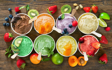 Various colorful ice cream sorts with fruits in paper cups