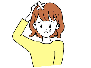女性　頭抱えて傷つく