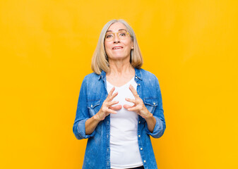 senior or middle age pretty woman scheming and conspiring, thinking devious tricks and cheats,...