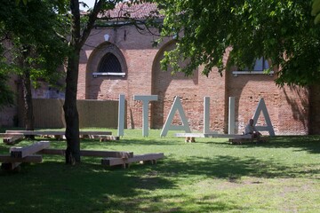"Italia" text in a garden in Venice during the Architecture Biennale