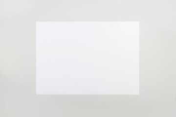 Blank paper sheet A3 size on on grey table background.