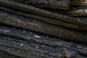 charred planks piled up after the fire
