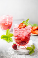 Refreshing summer drink with strawberry slices in glasses on white background
