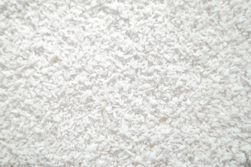 Coconut shavings close-up as background.