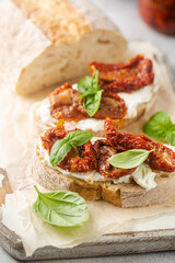 Bruschetta with sundried tomatoes, cottage cheese and fresh basil. Tasty savory Italian appetizers