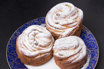 plate with homemade bakery on black table close up