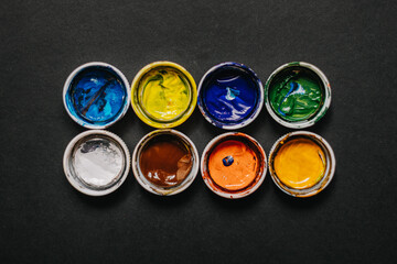 lids from jars of paint with remnants of paint on the back, background for the artist