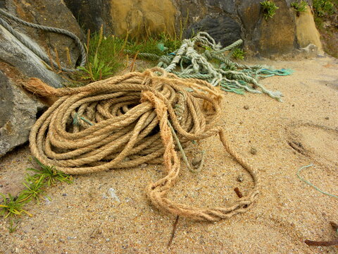 old dirty fishing ropes on a sandy beach