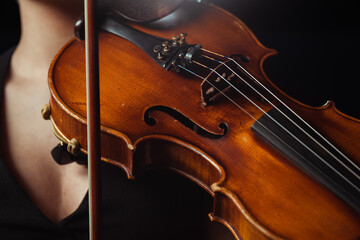 Fototapeta premium partial view of female musician playing symphony on violin isolated on black