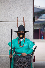 Covid 19/ Corona Serie 
Korean tourism, Gyeongbokgung Palace, Seoul 
Guard in mask