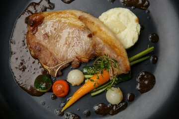 Pork chop with vegetables. Exquisite dish, creative restaurant meal concept, haute couture food.