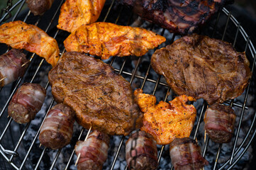 variation of steaks on the grill