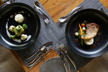 Exquisite dishes. Beautifully decorated healthy organic food served on the table. Modern creative restaurant meals.