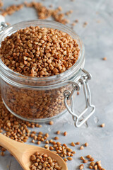 Raw dry buckwheat grain  in a jar with a spoon