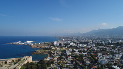 Fototapeta premium Cyprus Kyrenia Drone Footage from sky mountains city view Mediterranean sea Girne North Cyprus KKTC blue color best holiday summer sunny