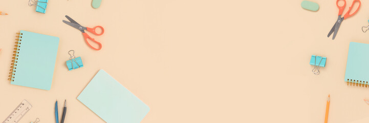 Banner with various stationery on a beige background. Back to school concept with place for text.
