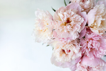 Decorative still life, flower arrangement. Wedding or holiday bouquet of delicate pink peony flowers. shabby white table background. Flat lay, top view. Summer concept. selective focus.