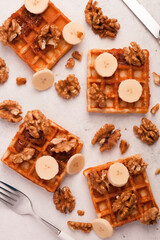 Fresh homemade Viennese waffles with sauce and honey for Breakfast or lunch. Honey, nuts, fresh fruit and bananas are perfect for a healthy snack