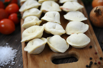 Fototapeta na wymiar Dumplings manual molding. Rustic food. Selective focus.