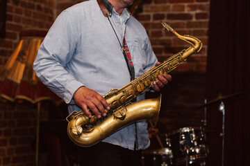 man playing saxophone in jazz restaurant