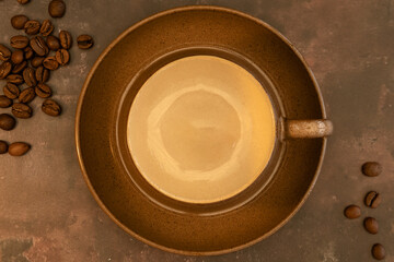 Empty coffee cup shot from above on a brown textured background