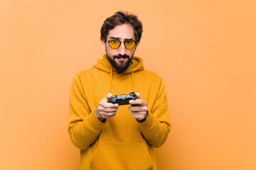 young crazy cool man paying with a game console controller - obrazy, fototapety, plakaty