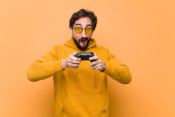 young crazy cool man paying with a game console controller - obrazy, fototapety, plakaty