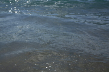 clear blue water at the beach on a summer day, blue ocean and transparent water