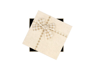 Beige coloured box with tartan ribbon shot against white background with copyspace/space for text