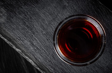 Soy sauce in small glass dish black background