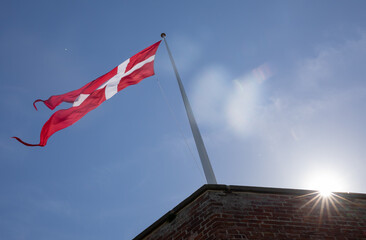 Danish flag with blue aky and a sun star