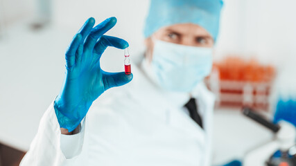 close up. capsule with a vaccine in the hands of a scientist.