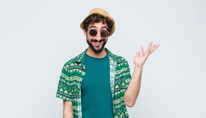 young tourist man feeling happy, surprised and cheerful, smiling with positive attitude, realizing...