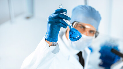 close up. medical flask in the hands of the researcher.